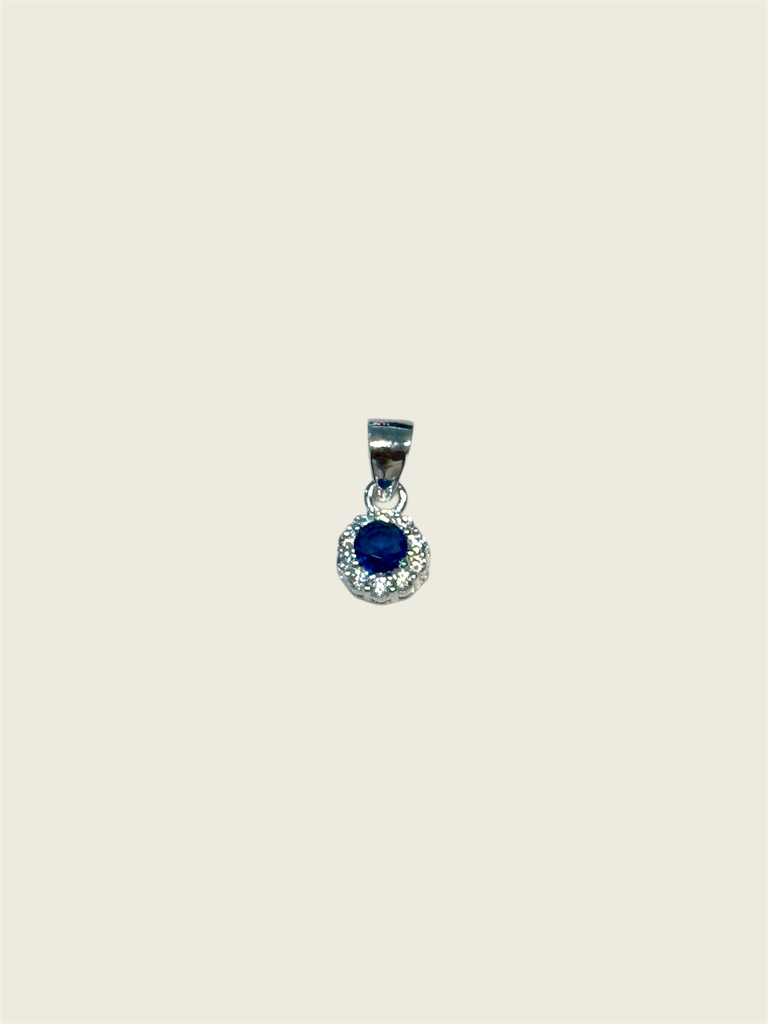 Dije en plata circón azul circular con marco de circones blancos pequeño
